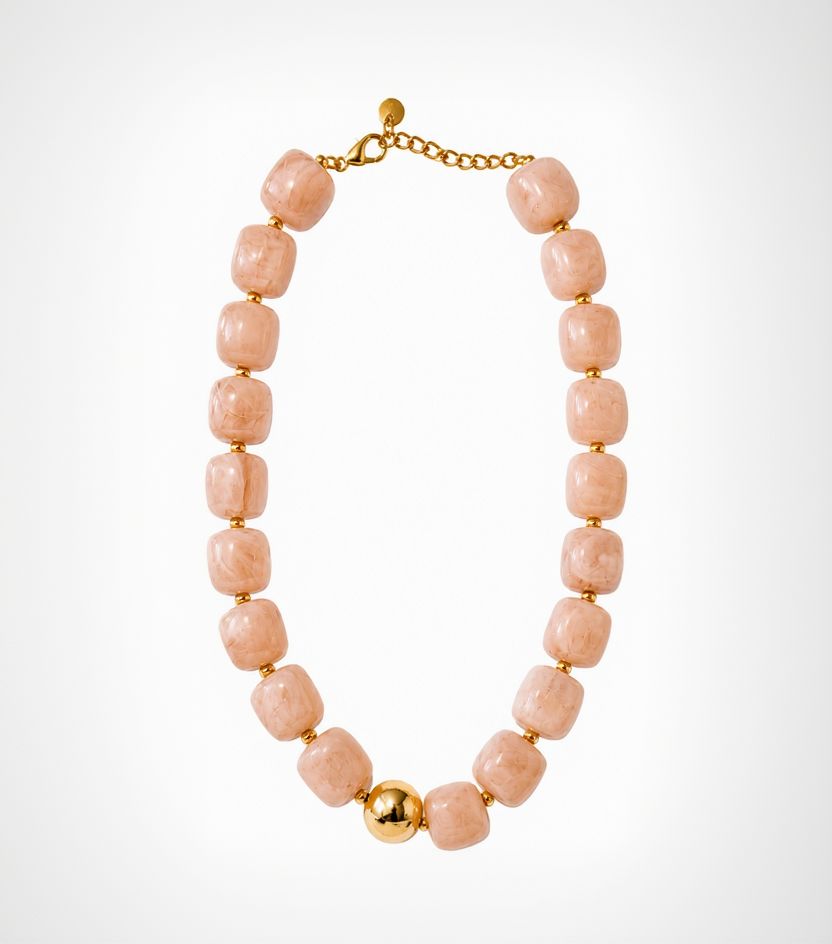 Necklace with pink beads and gold accents on a white background